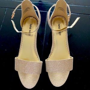 Girls dress shoes in a size 4.  They are gold with a glittery look.